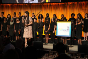 We McDonald performs with students on stage at gala