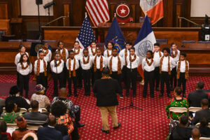 Student choir performing at the NYC council hall chambers